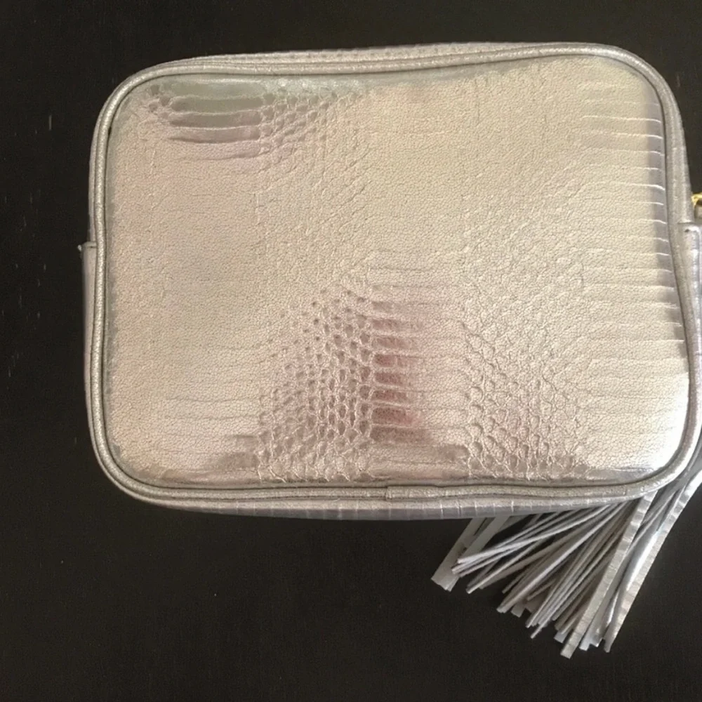 Victoria’s Secret silver snake skin purse with gold chain strap.
